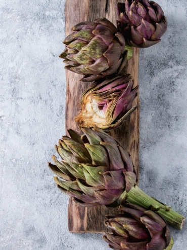 Uncooked purple artichokes