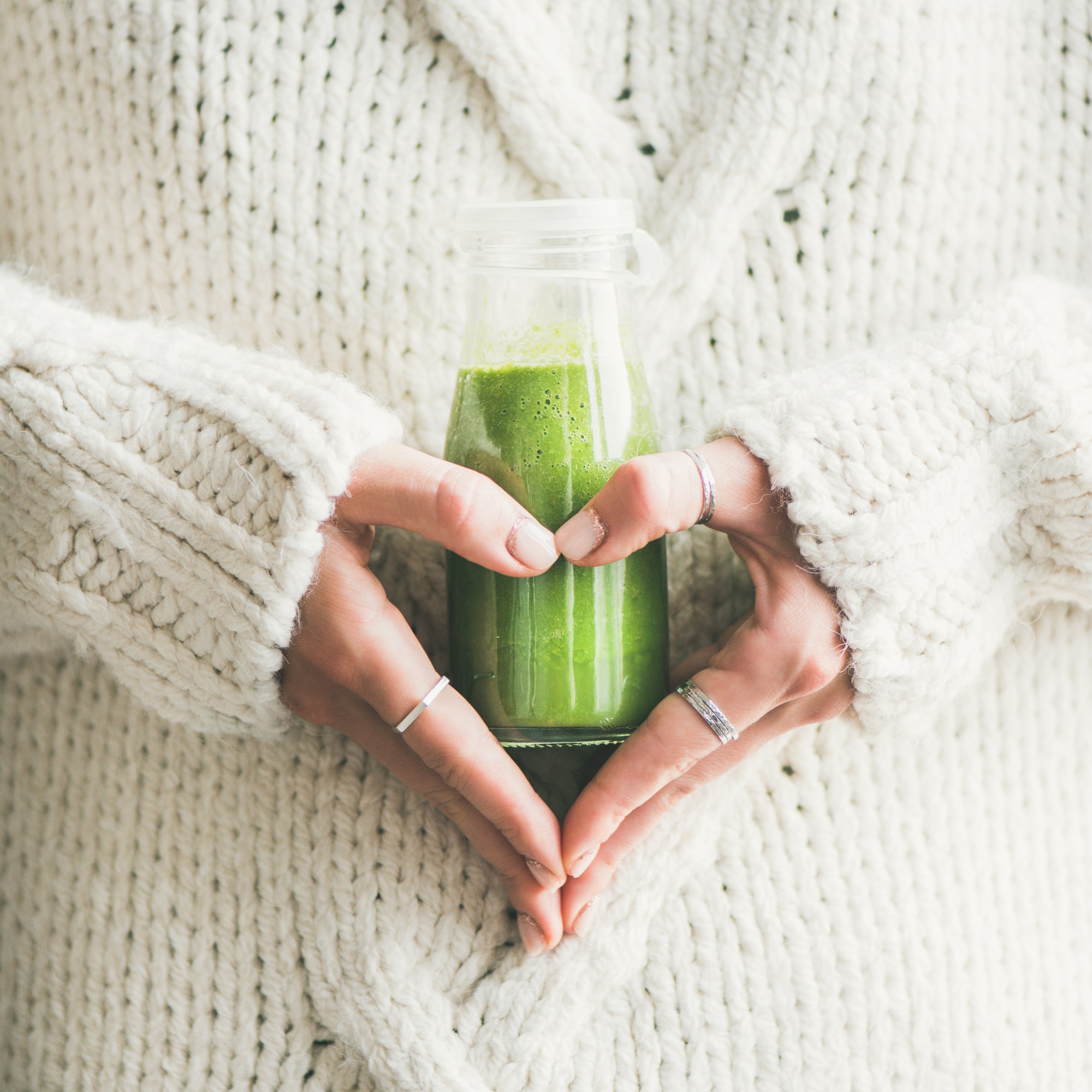 Winter seasonal smoothie drink detox in woman's hands, square crop